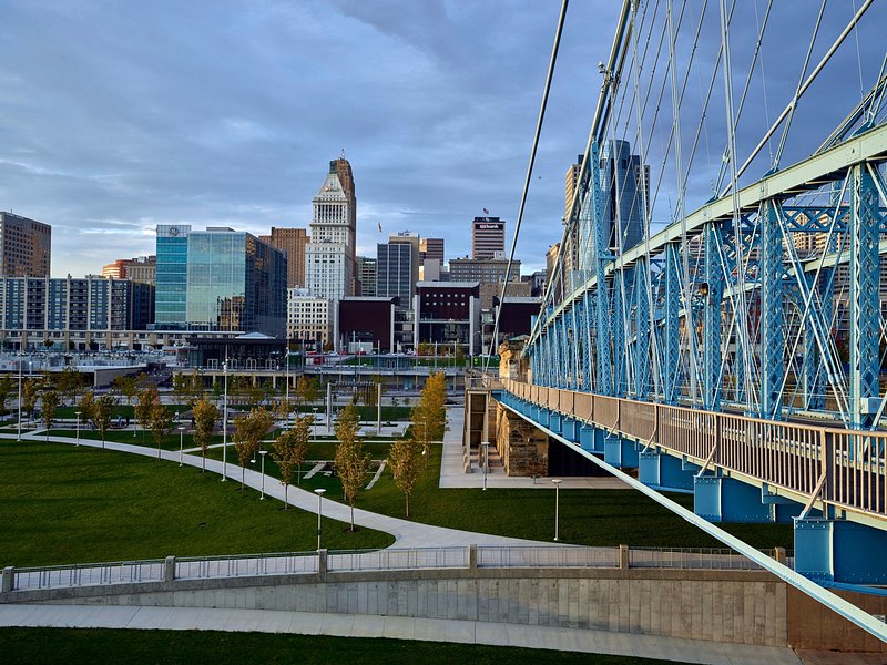 View of Cincinnati skyline with a blue bridge over a park